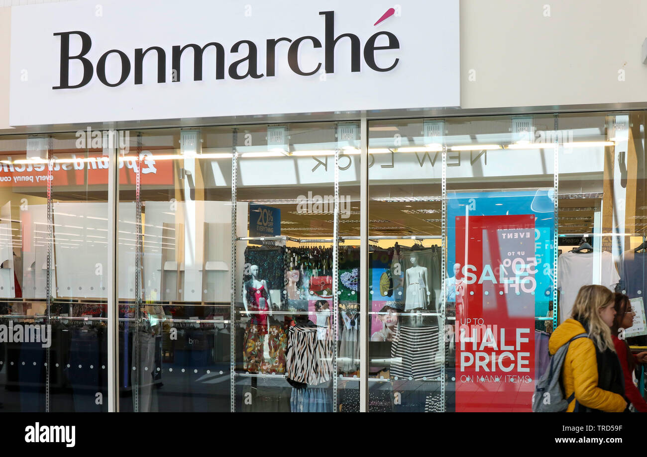 Interior of Bonmarche shop and stock viewed through window with people walking past. Stock Photo