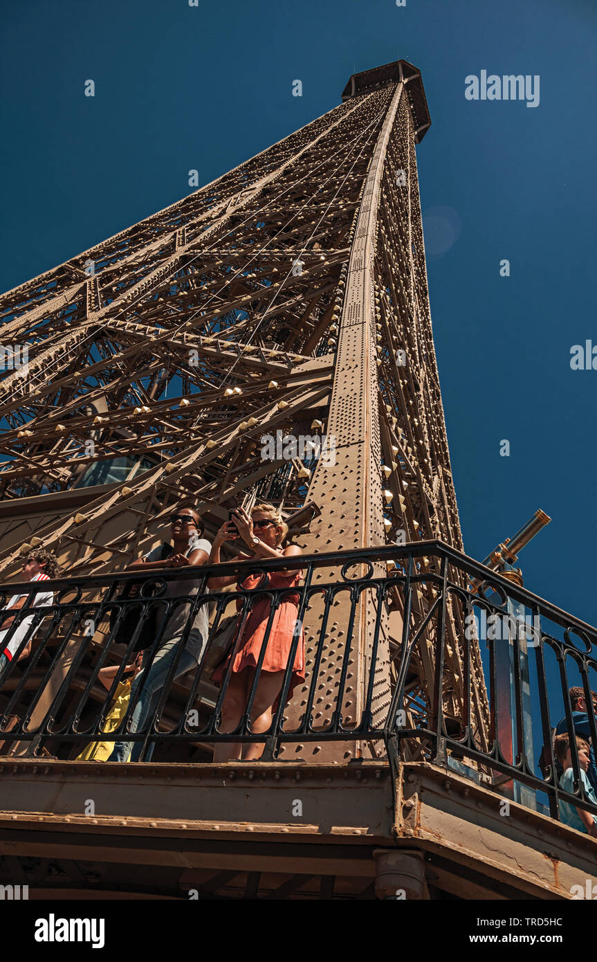 People on Eiffel Tower top with blue sky and sunshine in Paris. One of the most impressive world's cultural center in Photo - Alamy