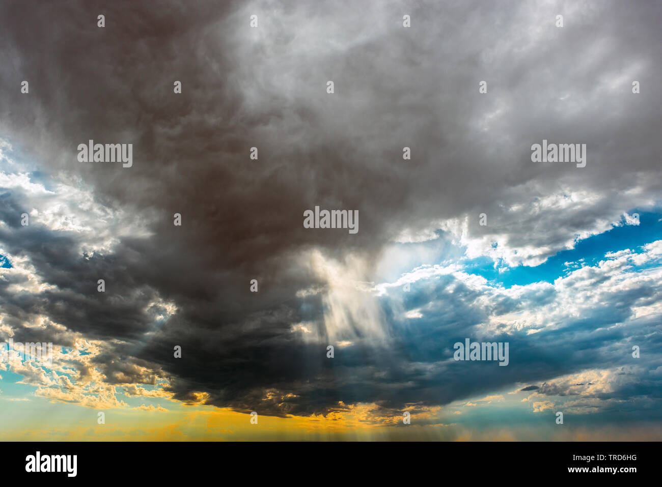 Cloudscape with colorful sky and sunbeam with light rays at sunset. Concept of God, heaven, wisdom, religion and spirituality. Stock Photo