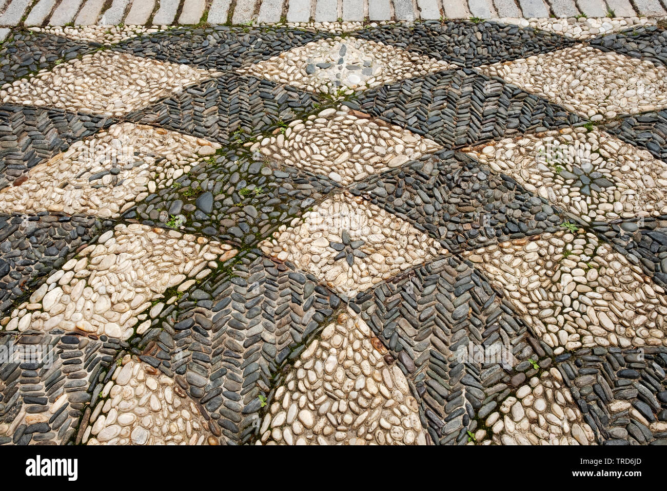 A beautiful pattern of light and dark color stones outside the Vanderbilt Museum in Centerprot, Long Island, New York. Stock Photo