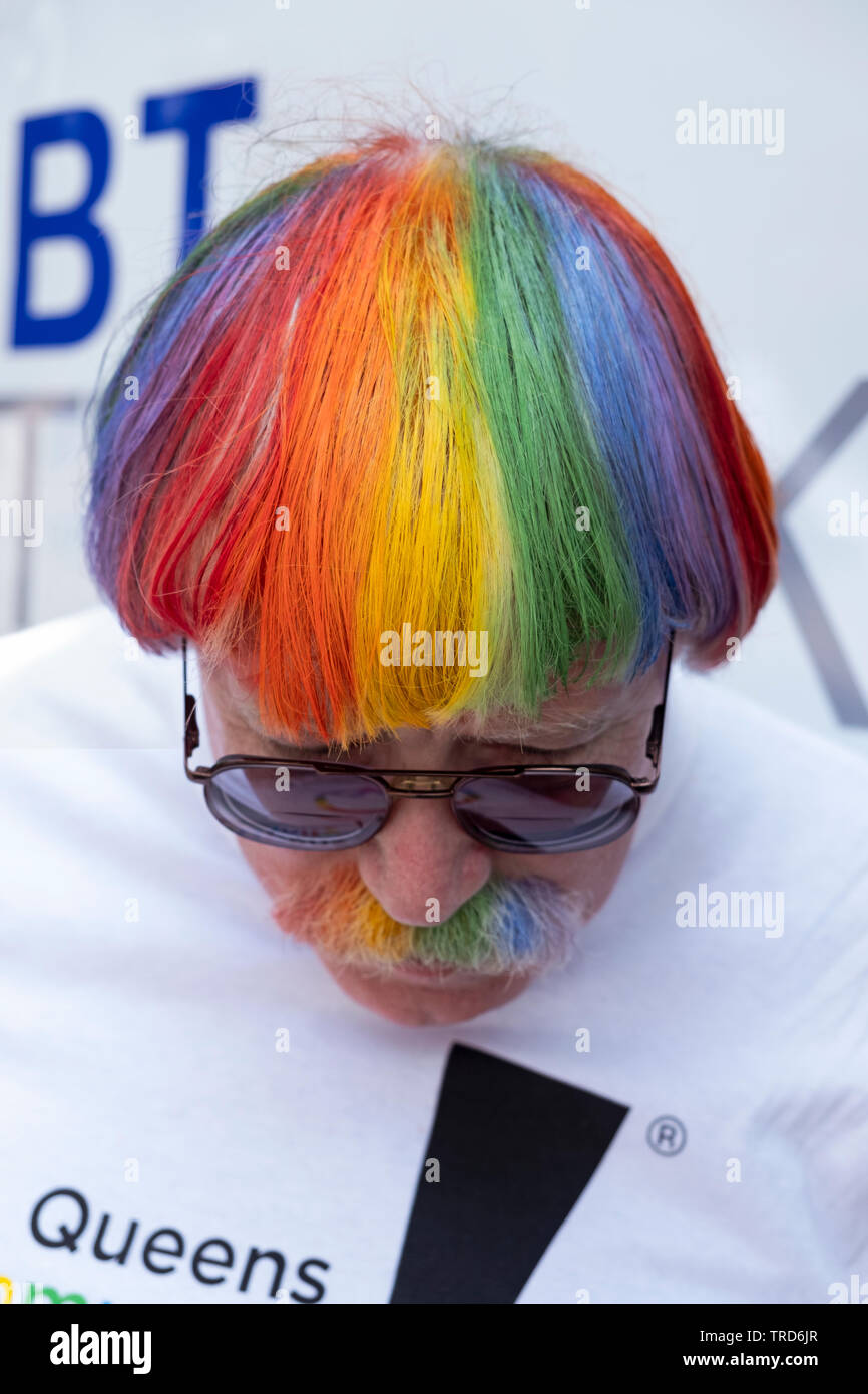 An Irish American man who dyed his hair and mustache in the colors of the LGBT flag at the 2019 Queens Pride Parade in Jackson Heights, Queens, NYC. Stock Photo