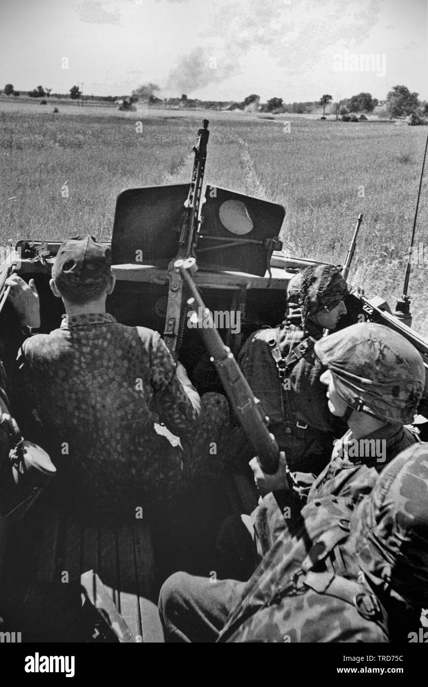 Waffen SS Panzer Grenadiers in Camouflge Smocks and Uniforms ride in an Armoured Personnel Carrier Sdkfz 251 in Poland on the Eastern Front 1944 SS KB Ernst Baumann Stock Photo