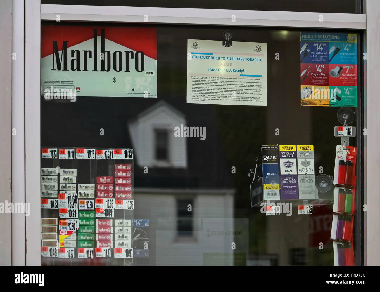 Cromwell, CT / USA - May 4, 2019: Window at a gas station displaying cigarettes for purchase and the appropriate warnings Stock Photo