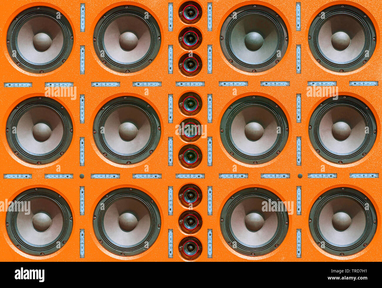 Multiple Rows of Sound Speakers, Led Light Strips on Orange Background. Stock Photo