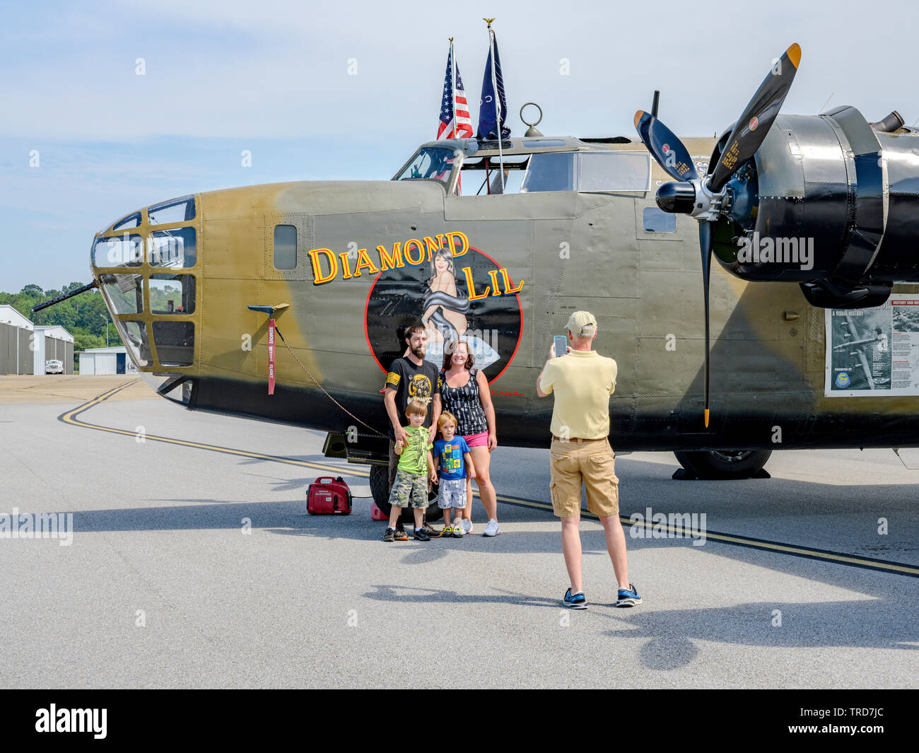 WWII or WW2 B-24 Liberator bomber on display with a family or tourists taking pictures of the American WWII bomber in Montgomery Alabama, USA. Stock Photo