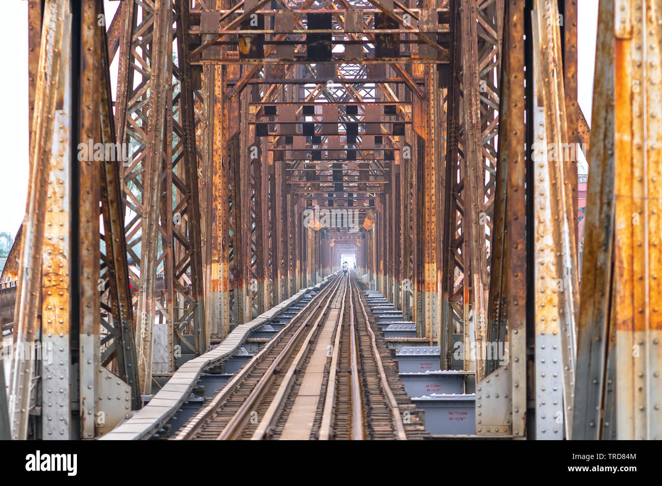 Vintage railroad tracks leading over the famous Long Bien Bridge, Hanoi