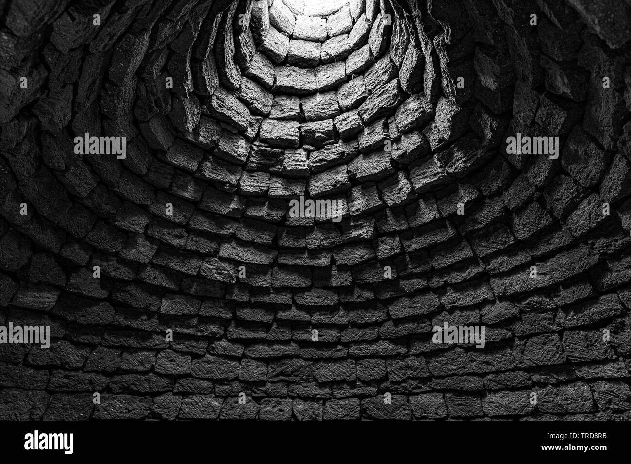 Deep ancient well inside Stock Photo