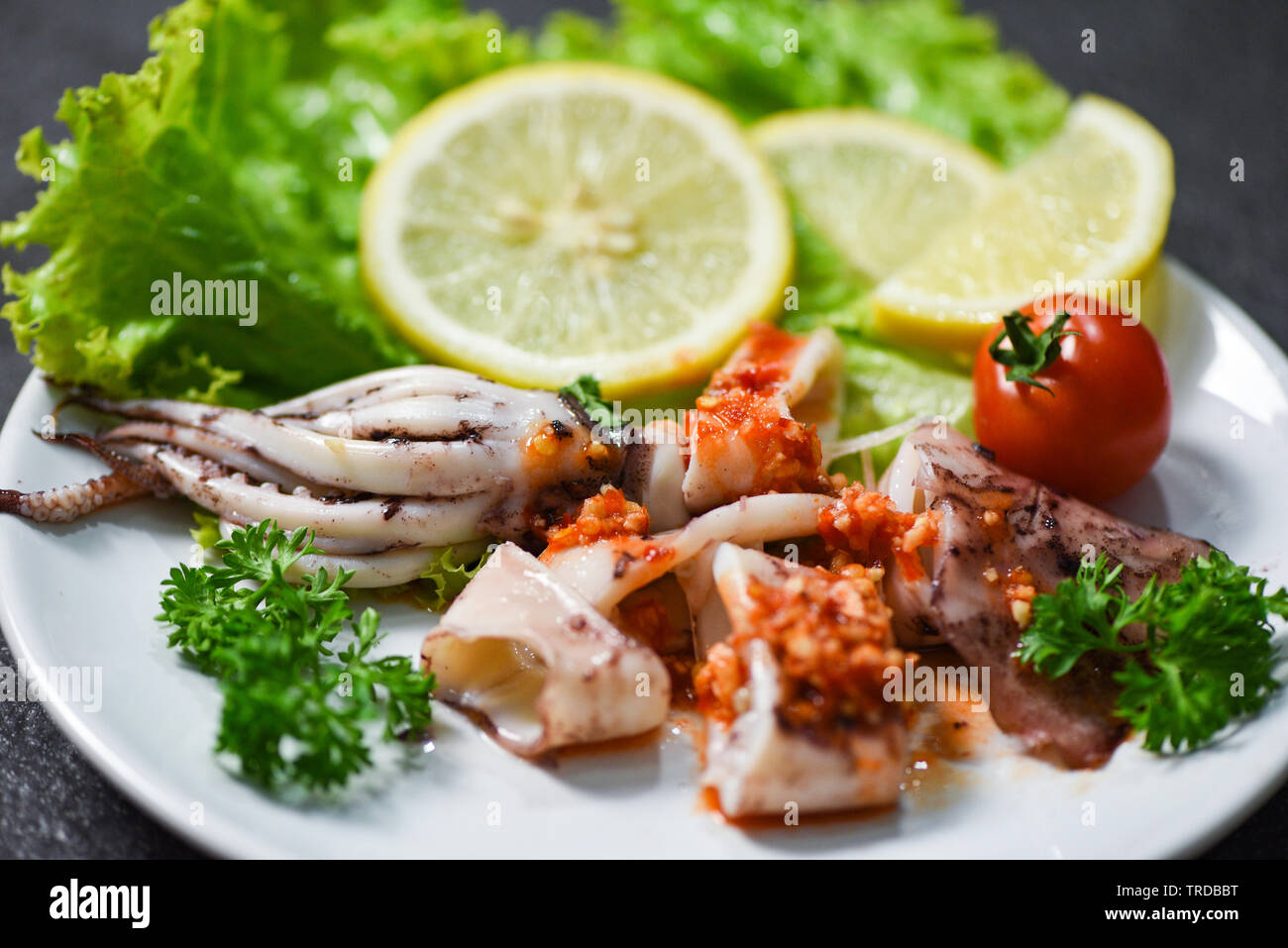 Squid salad with chilli sauce spicy herbs and spices / Grilled squid