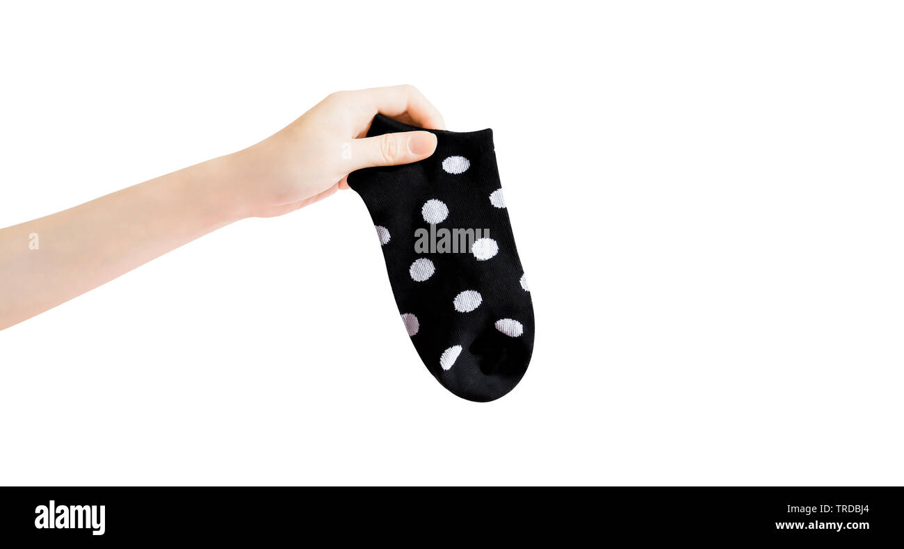 Sock with Black and White Dots with Clipping Path. Beautiful Woman Holding Fabric Short Sock and Space for Design on White Background. Warm Polka Dot. Stock Photo