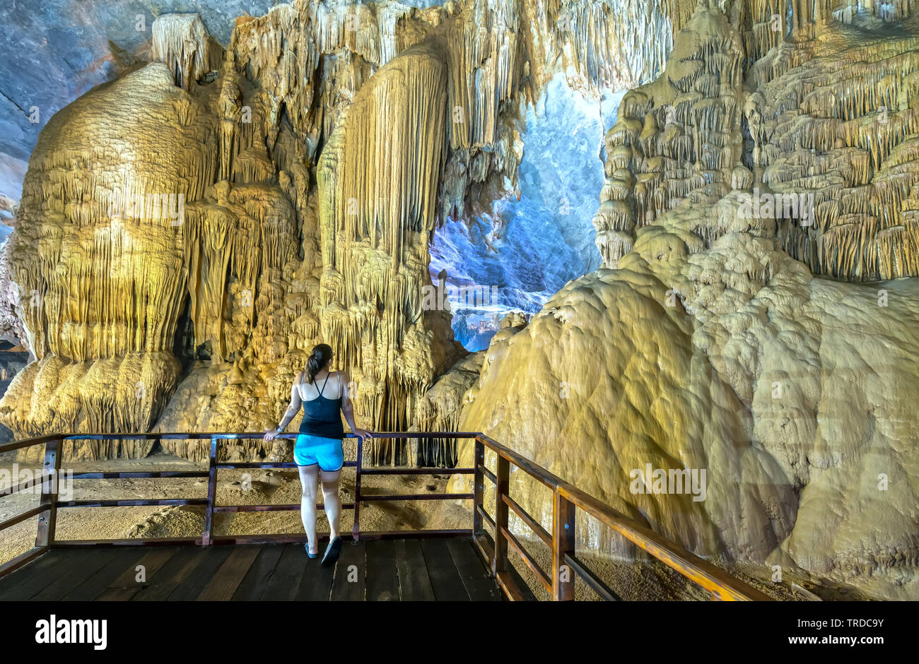Back view silhouette traveler woman watching Paradise Cave with stalactites and stalagmites in Phong Nha national park, Quang Binh, Vietnam Stock Photo