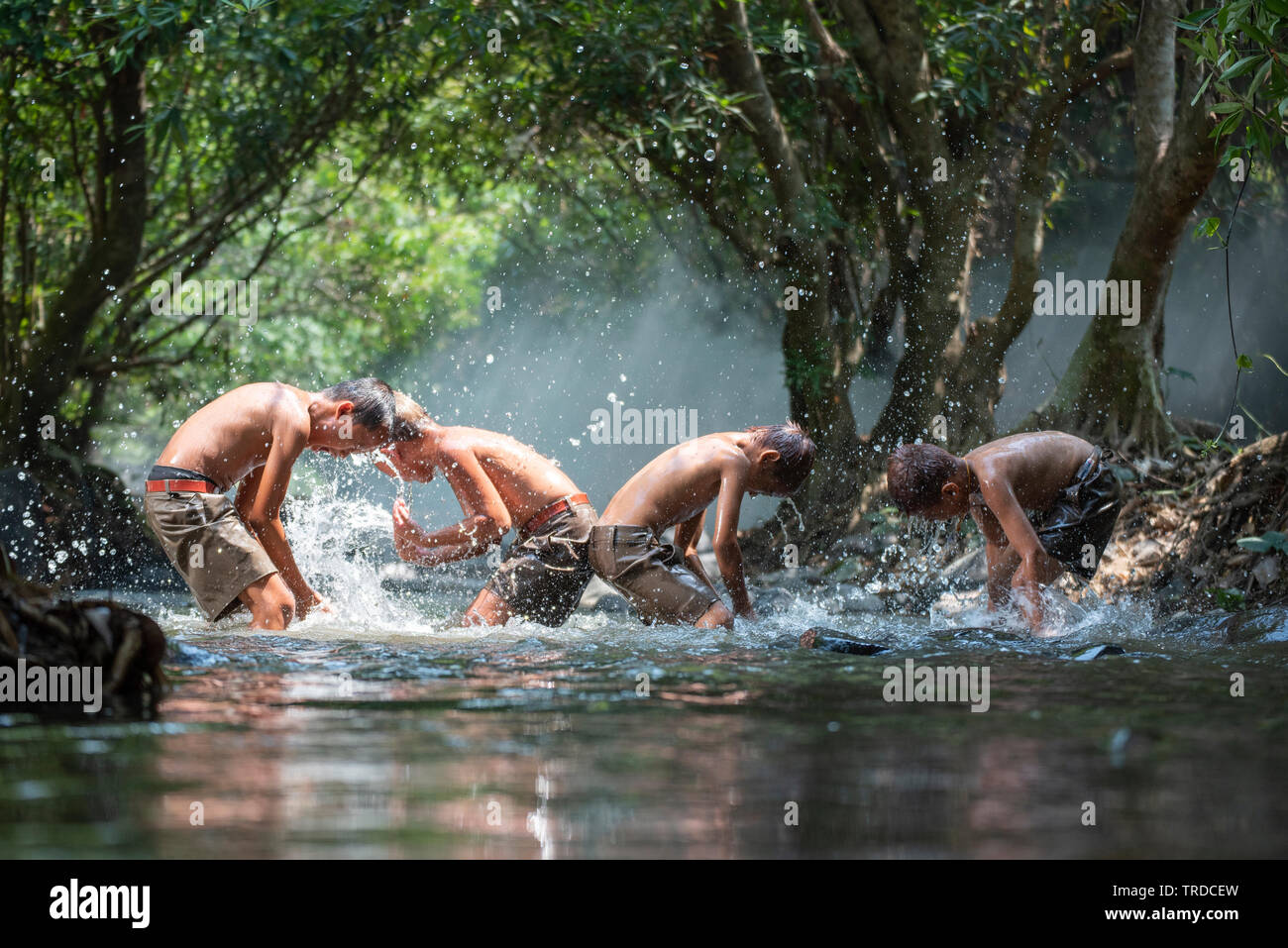 Asia children on river / The boy friend happy funny playing water in the  water stream in countryside of living life kids farmer rural people Stock  Photo - Alamy