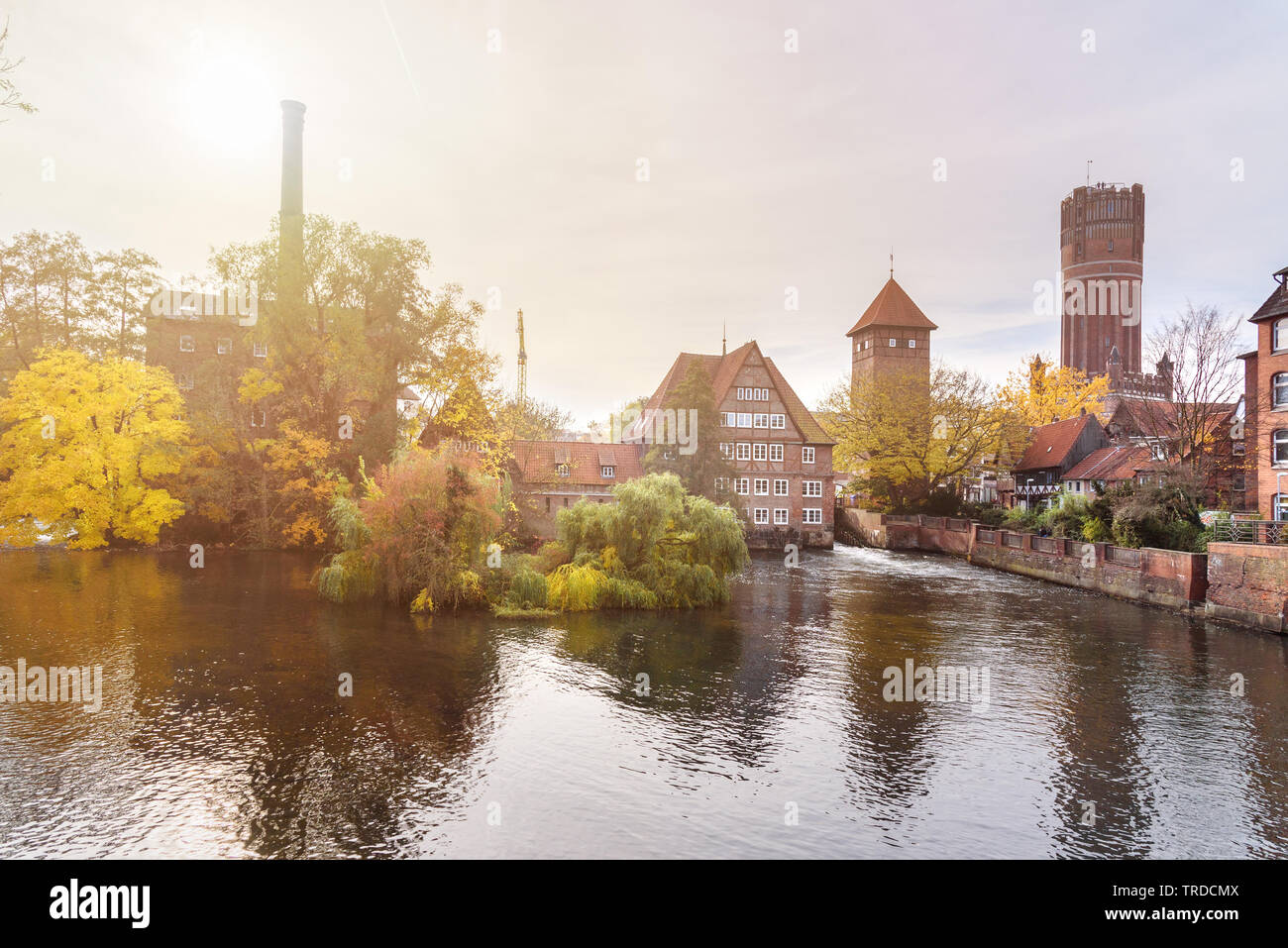 Ratsmuhle or old water mill and Wasserturm or water tower on Ilmenau river at morning in Luneburg. Germany Stock Photo