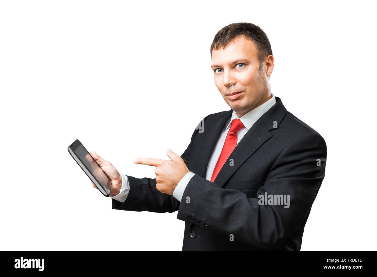 Portrait of a likeable Businessman in a black suit pointing towards a tablet in his hands Stock Photo