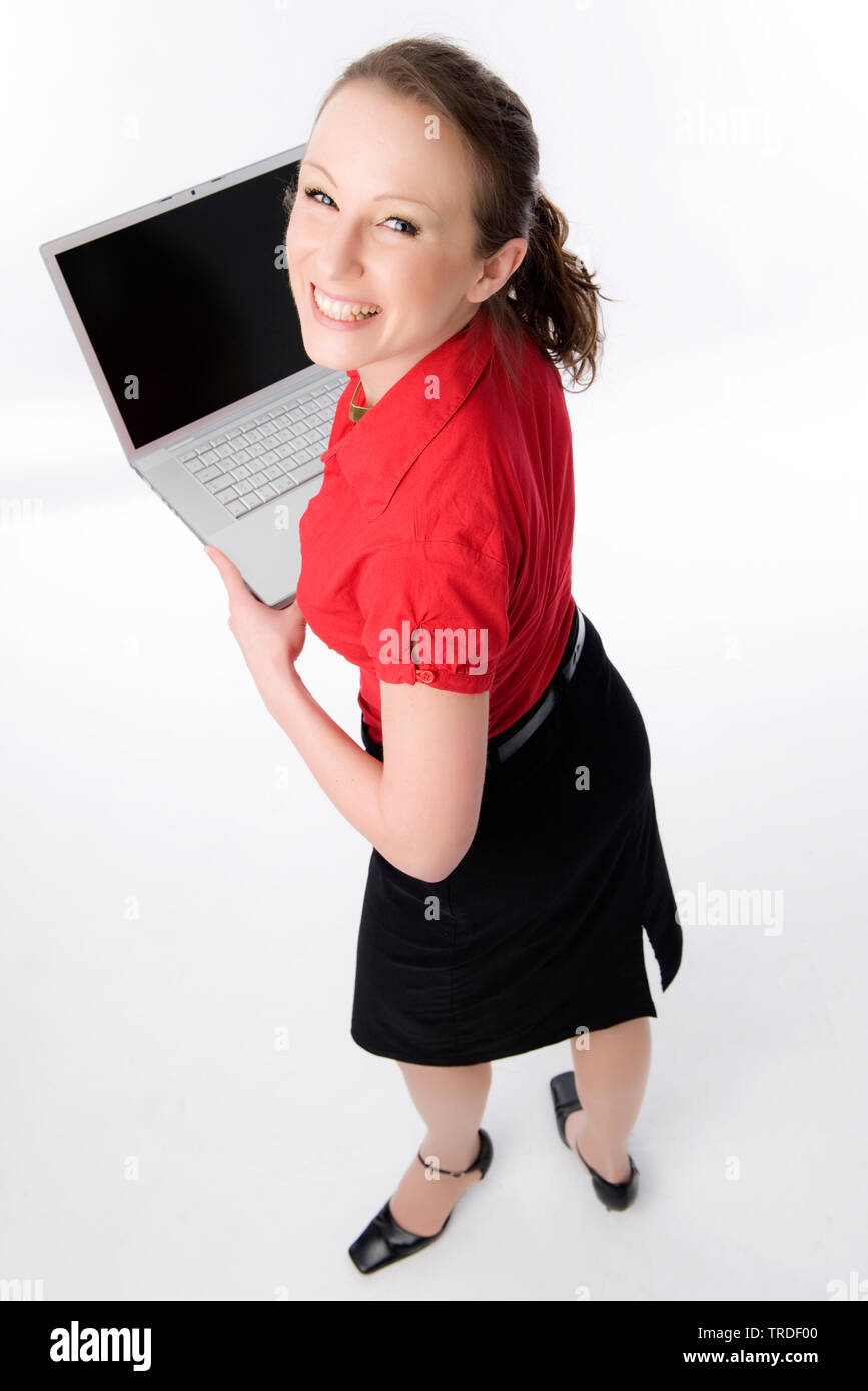 Portrait of a young likeable Business woman holding a laptop and smiling into the camera Stock Photo