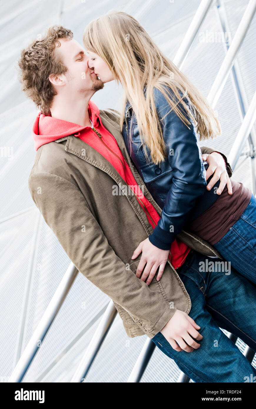 Portrait of a young couple hugging and kissing each other outdoors Stock Photo