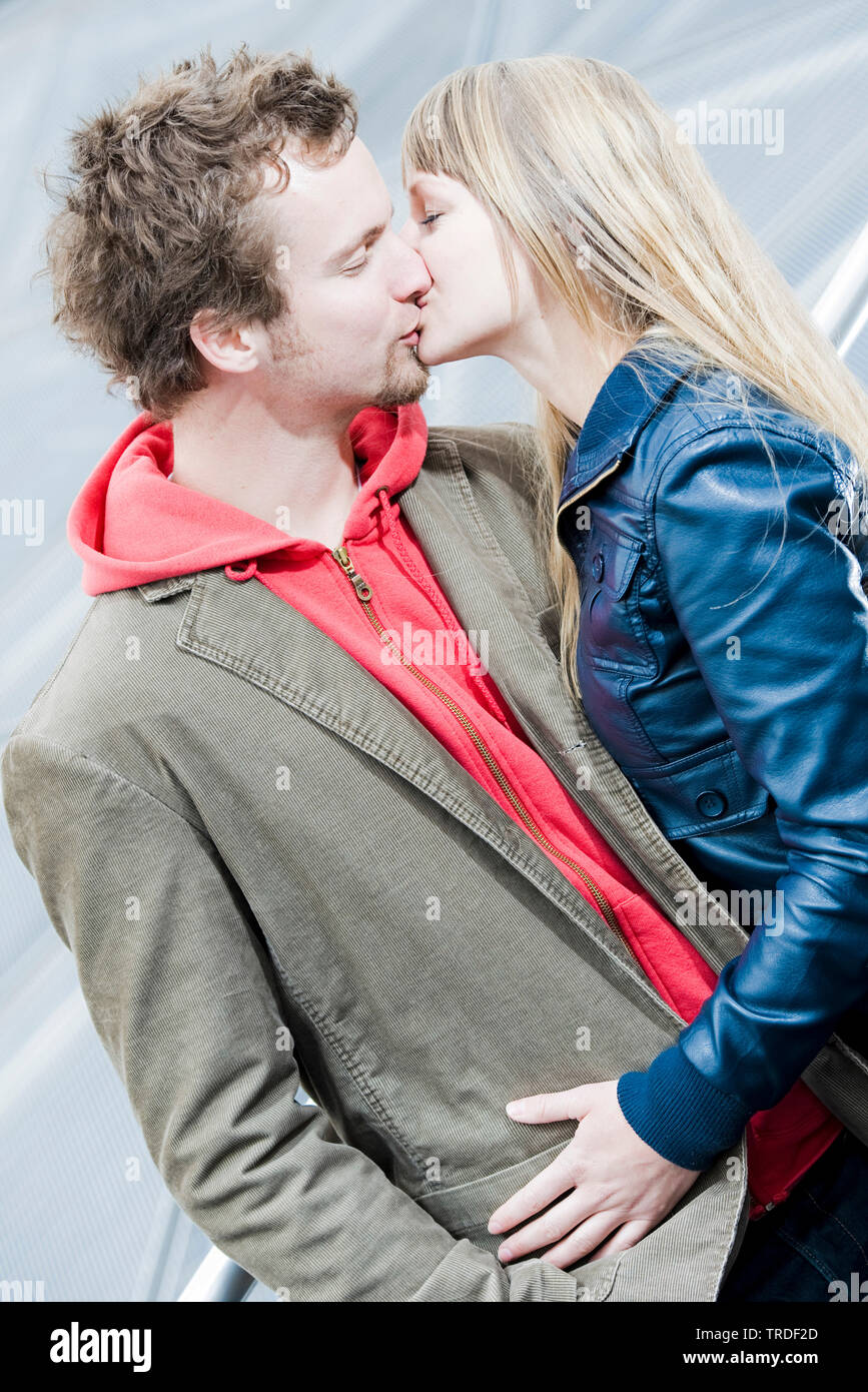 Portrait of a young couple hugging and kissing each other outdoors Stock Photo