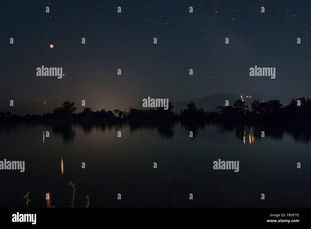 total lunar eclipse, 27.07.2018, blood moon and Mars mirroring in a lake, Germany, Bavaria, Lake Chiemsee Stock Photo