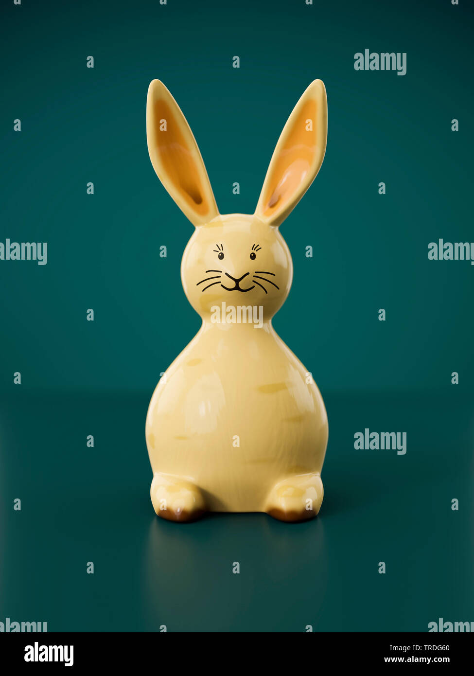 Ester card - Three-dimensional Easter Bunny in beige color against green background Stock Photo