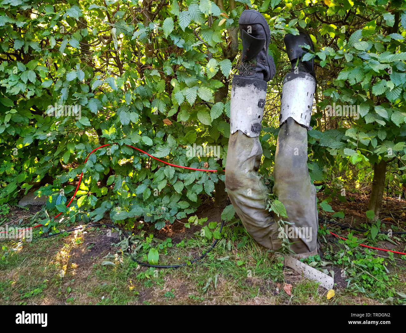 sculpture of mineworker stuck head first in the soil, Germany Stock Photo