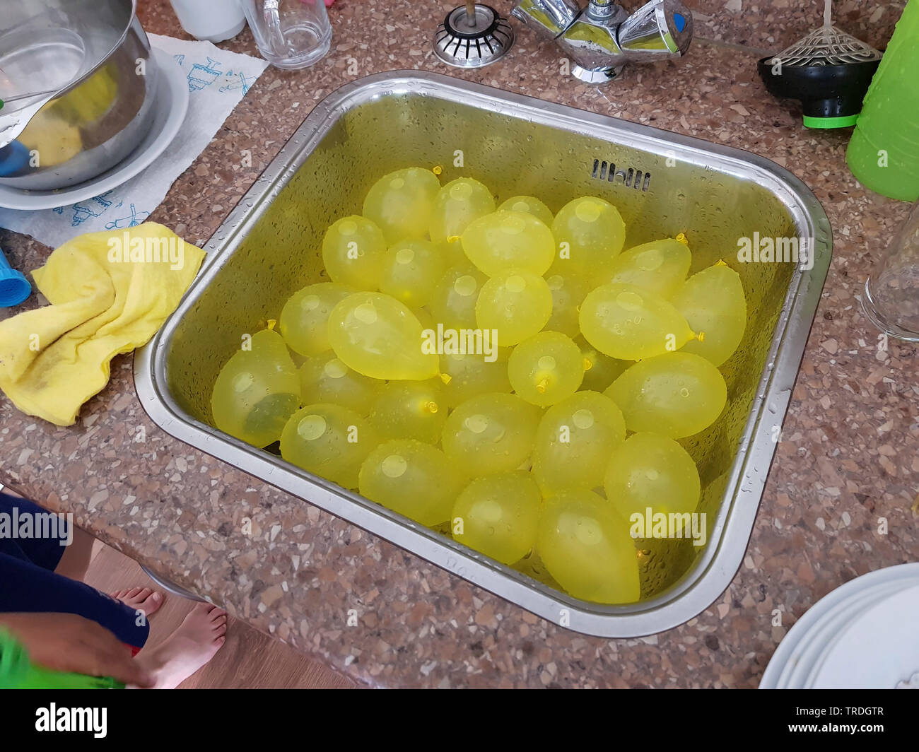 filled water bombs in a washbasin, Germany Stock Photo