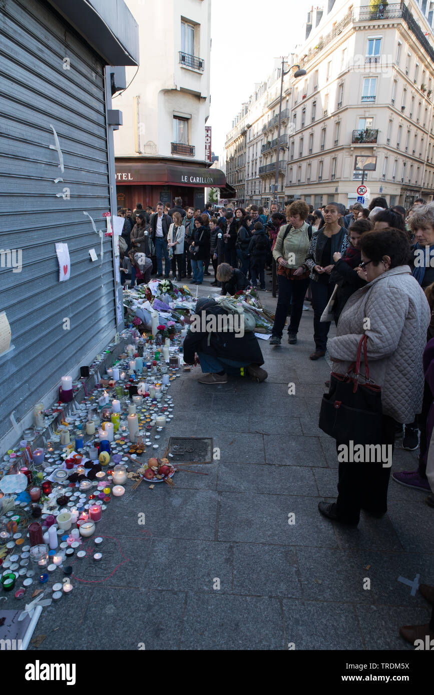 Two days after the Paris attacks (2015) -130 people dead & 413 injured - people dropped flowers and candles in front of one of the restaurants. Stock Photo