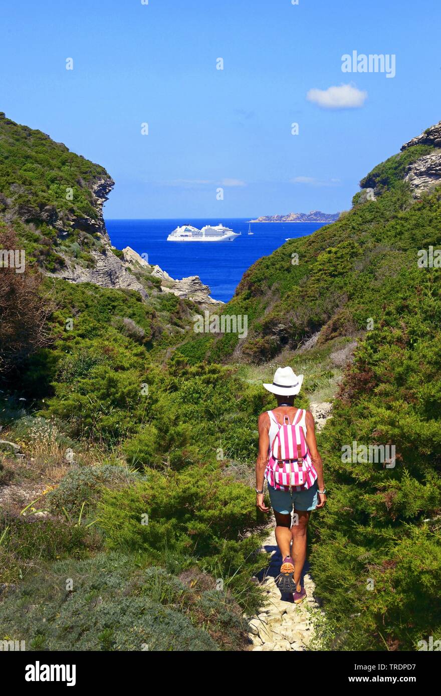 footpath at the rocky coast, cruise liner in background, France, Corsica, Bonifacio Stock Photo
