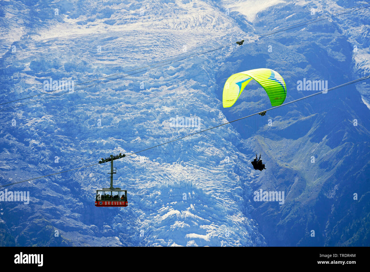 Paragliding and cablecar Telepherique du Brevent in front of the glacier of Mont Blanc massif, France, Savoie, Chamonix Stock Photo