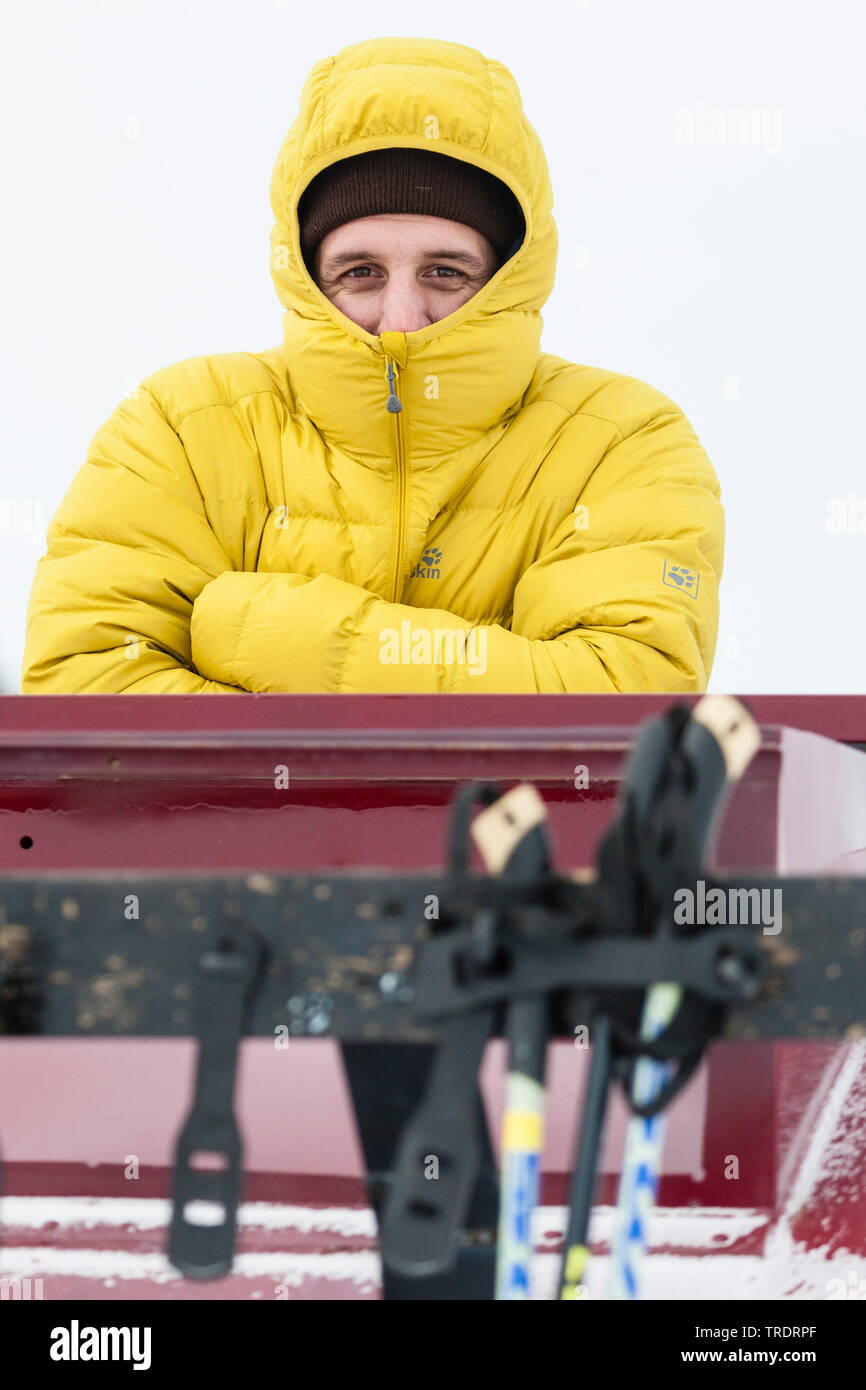 man hiding from cold in jacket, USA, Wyoming, Yellowstone National Park Stock Photo