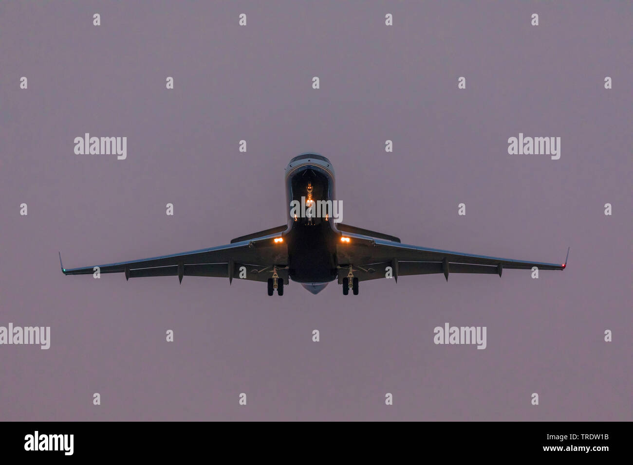 Bombardier CR900 landing in the evening, Germany, Bavaria, Flughafen Muenchen Stock Photo