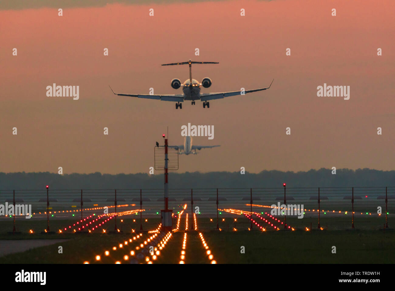 Bombardier CR900 landing in evening light, Germany, Bavaria, Muenchen Stock Photo