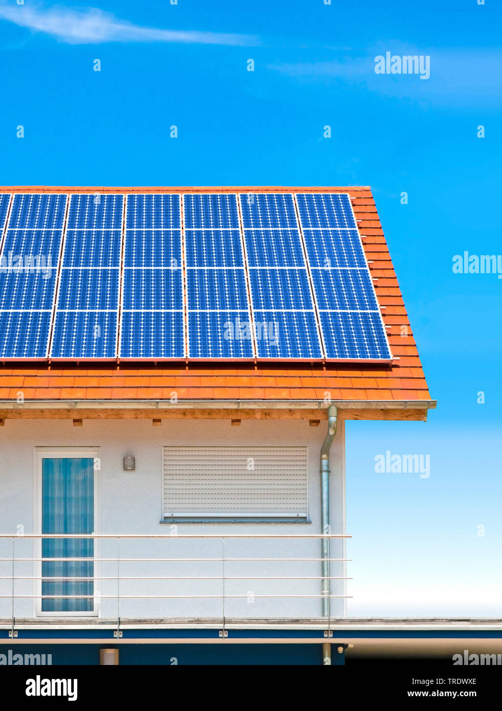 Detail of residental house roof with solar panels against blue sky Stock Photo