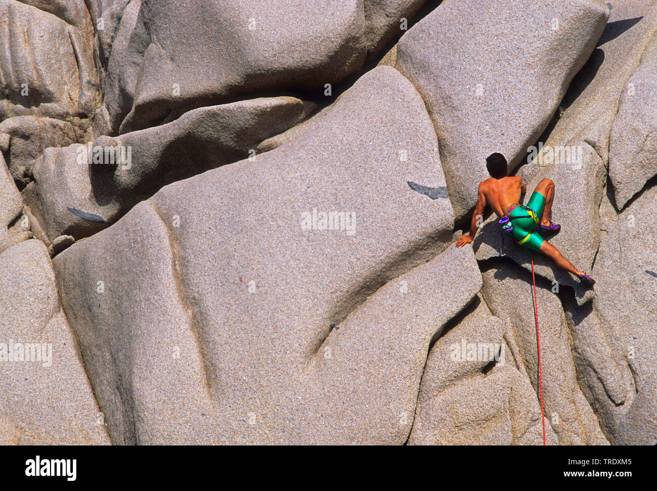 climber on rock of Capo Testa, Italy, Sardegna, Santa Teresa Gallura Stock Photo