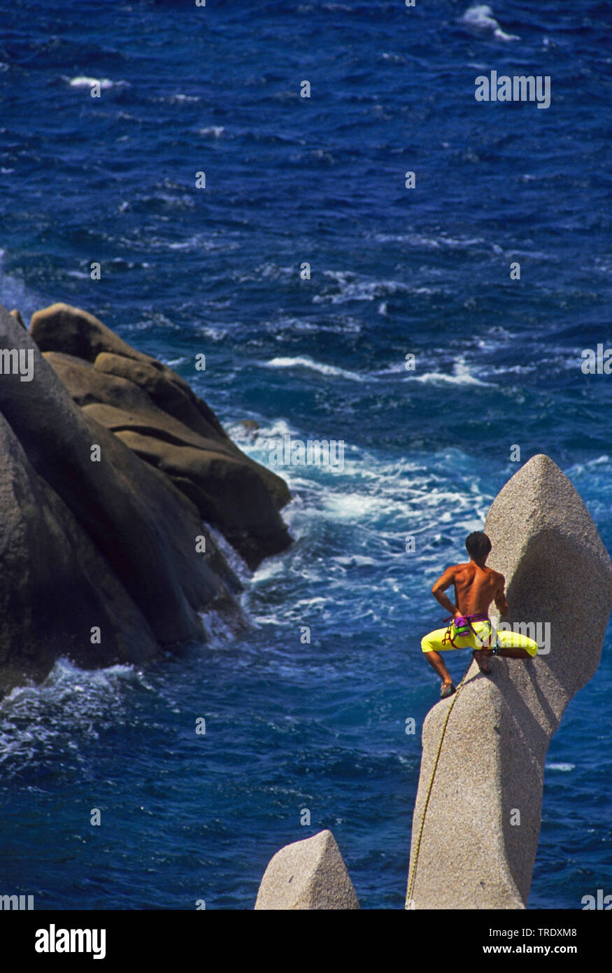 climber on strange rock in Capo Testa, Italy, Sardegna, Santa Teresa Gallura Stock Photo