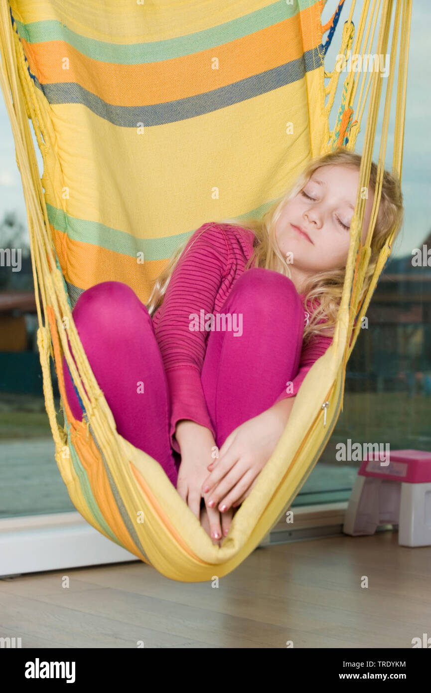 Portrait of a girl relaxing with closed eyes in a hammock Stock Photo