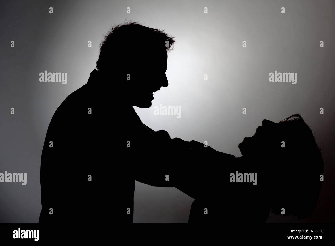 Black&White silhouette of a man chocking a woman Stock Photo