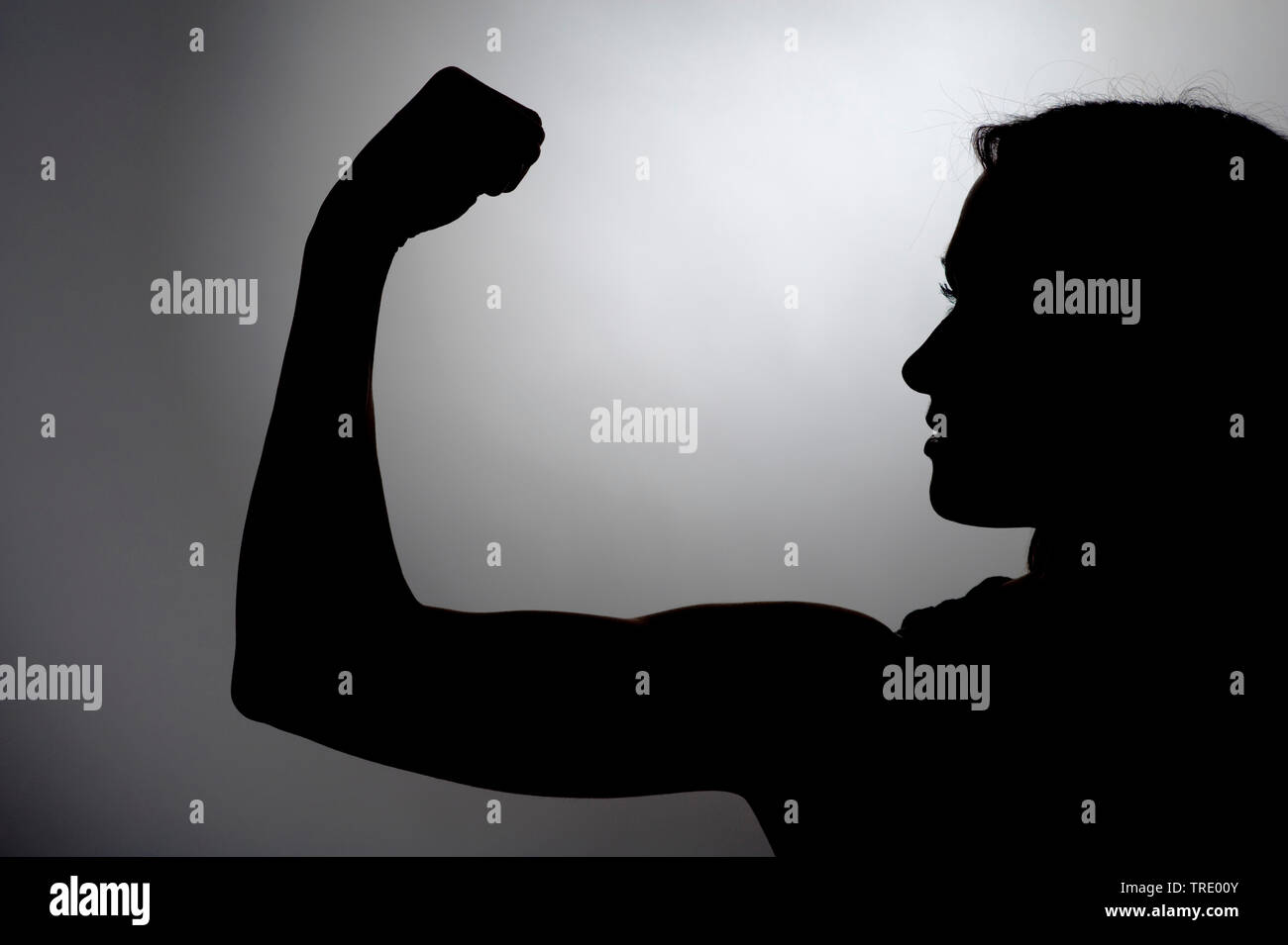 Black&White silhouette of a woman with toned bicepts Stock Photo