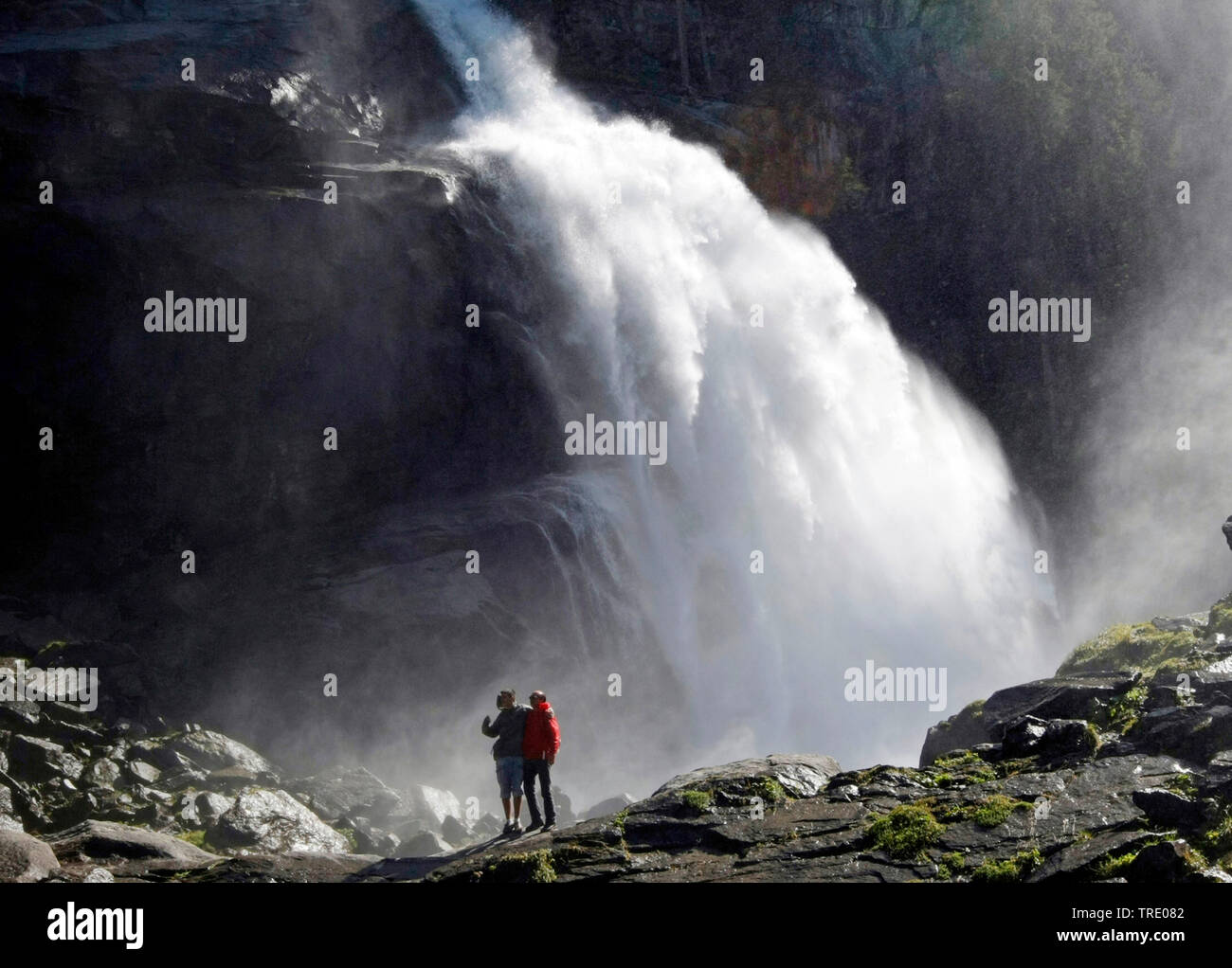 Two montain hiker in front of the Krimml Waterfalls in Salzburg state, Austria, Salzburger Land, Krimml Stock Photo