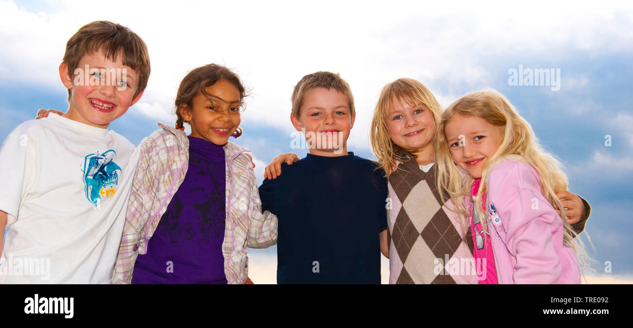 Group picture of 5 hugging children of multi-ethnic origin Stock Photo