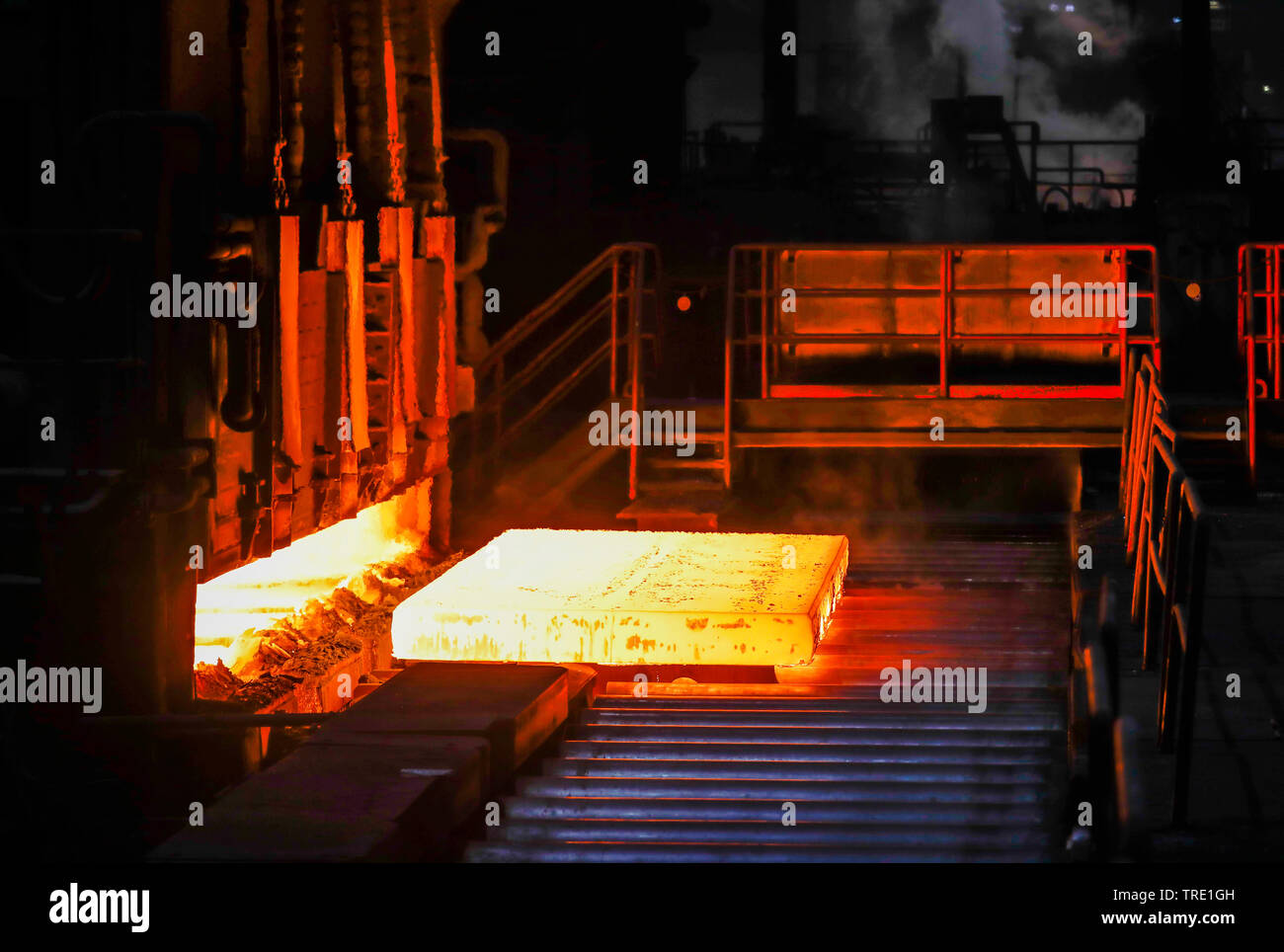 Duisburg, Ruhr area, North Rhine-Westphalia, Germany - ThyssenKrupp Steel Europe, steel production in a steel mill, here glowing steel slabs in a hot Stock Photo