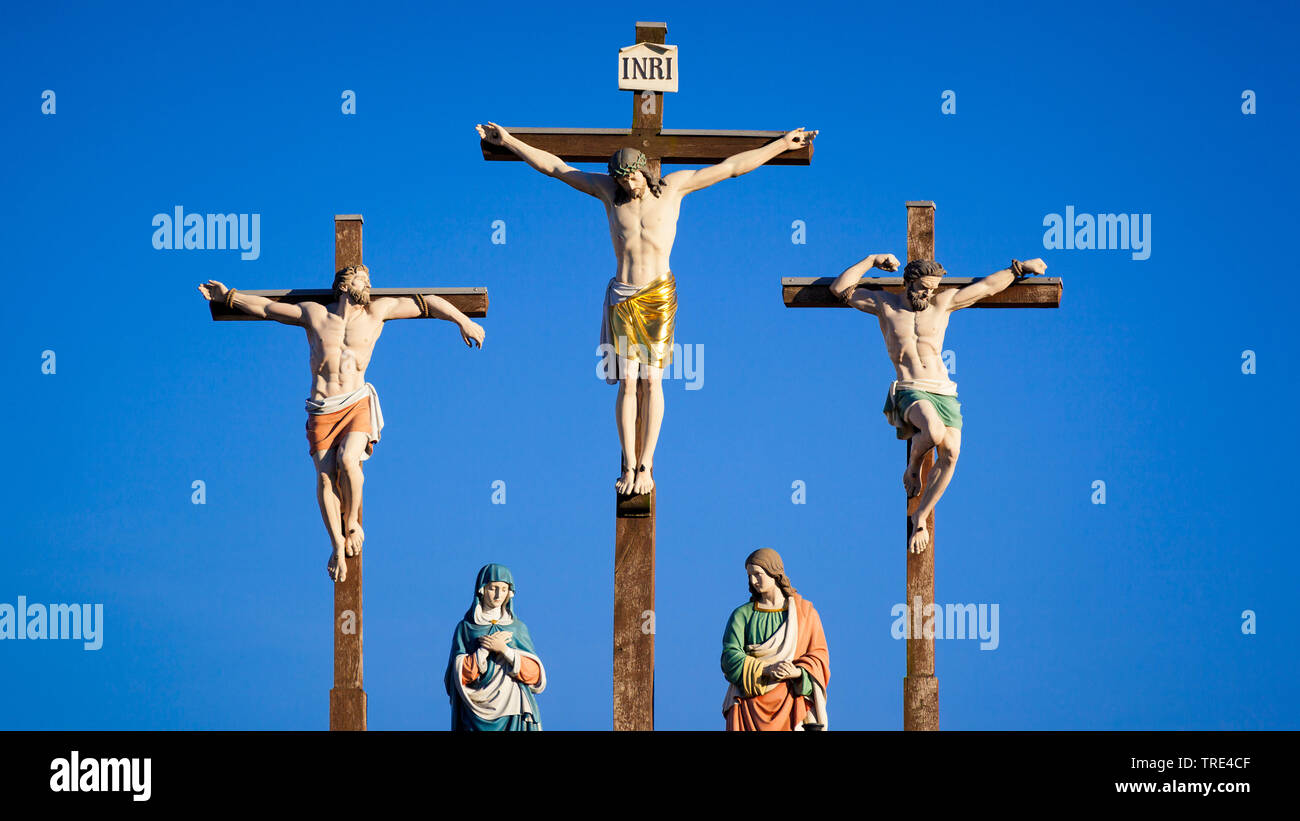 Crucifixion group against clear blue sky, Europe Stock Photo