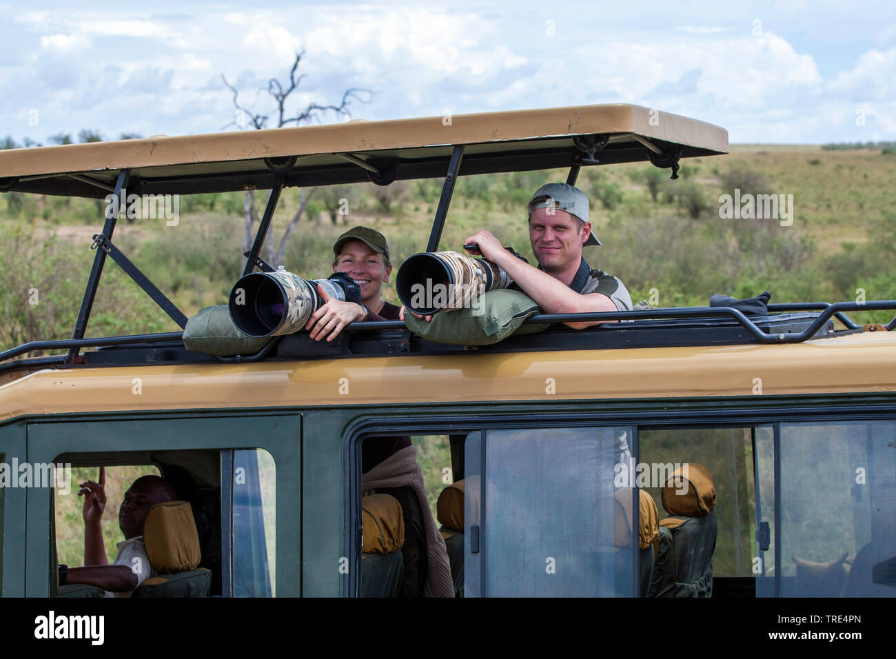 animal photographers in a safari jeep, Kenya, Masai Mara National Park Stock Photo