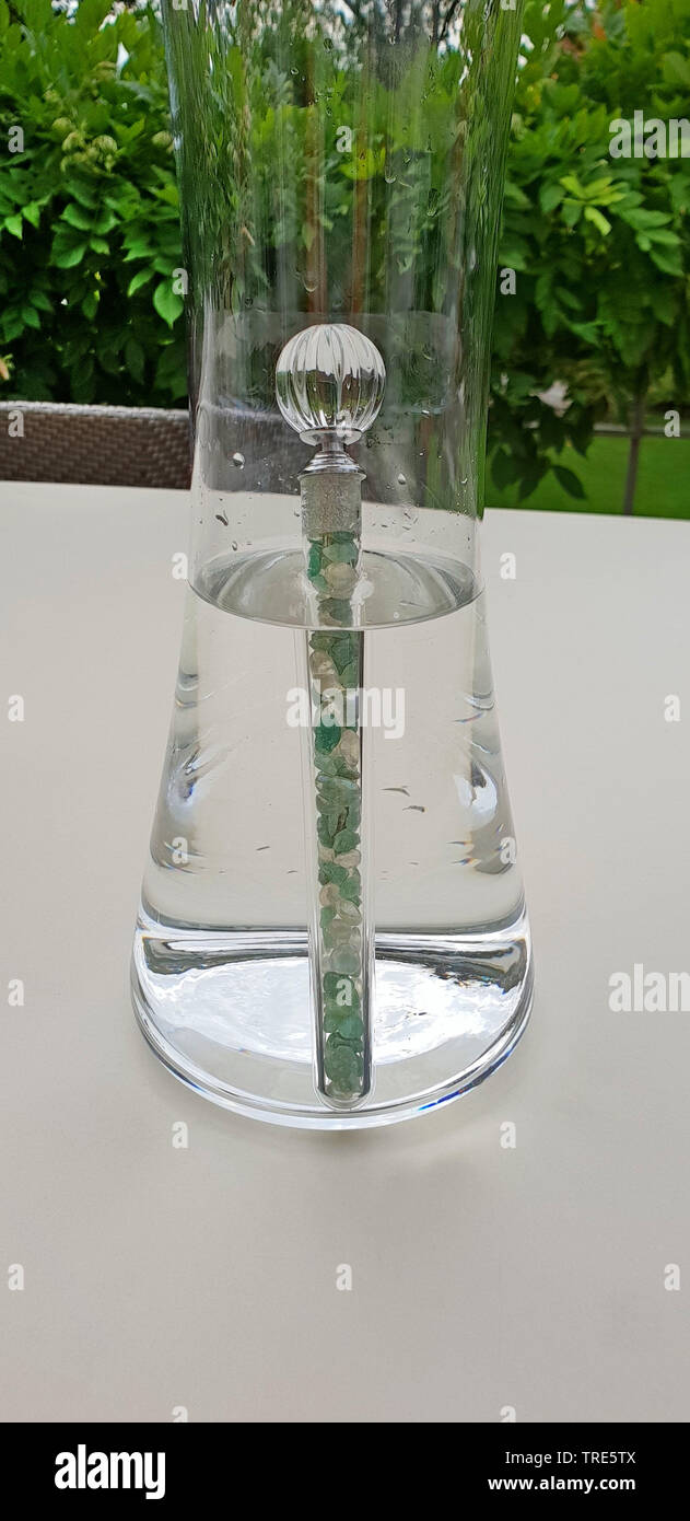healing stone in a water carafe for energetical purging Stock Photo