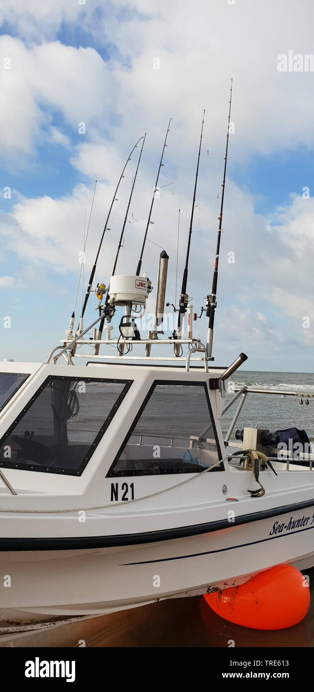 boat with a lot of fishing rods on the beach of the North Sea, Netherlands  Stock Photo - Alamy