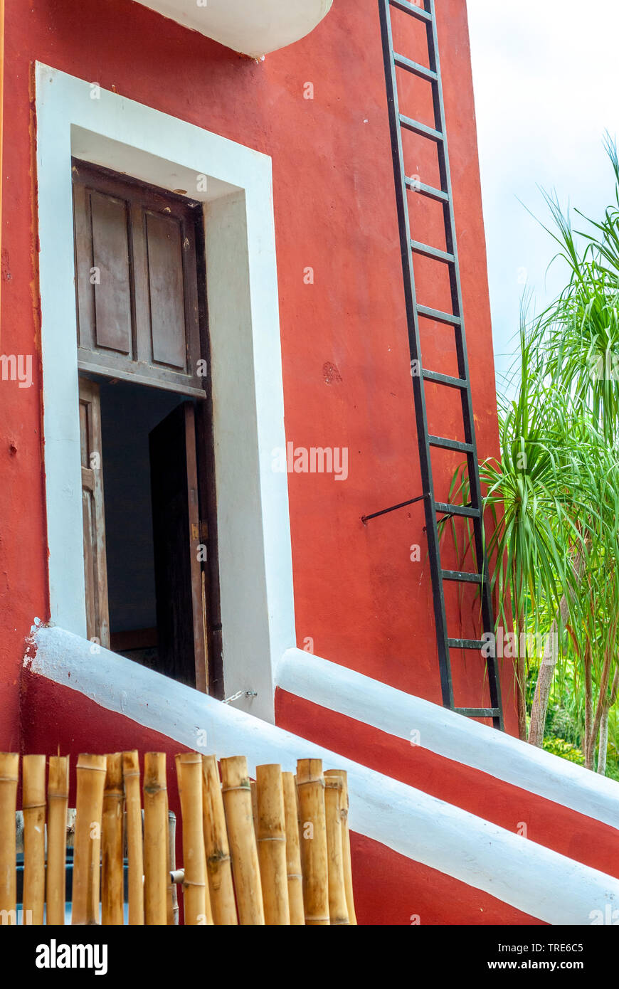 Typical Mexican residential entrance, of a red colored house, taken from Tecoh, in the Yucatan peninsula Stock Photo