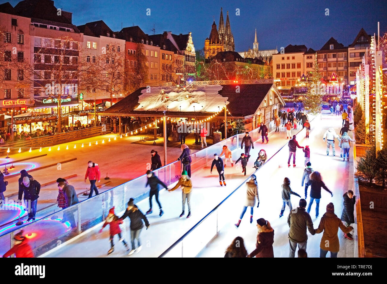 ice skating on the Heumarkt in the evening, Germany, North Rhine