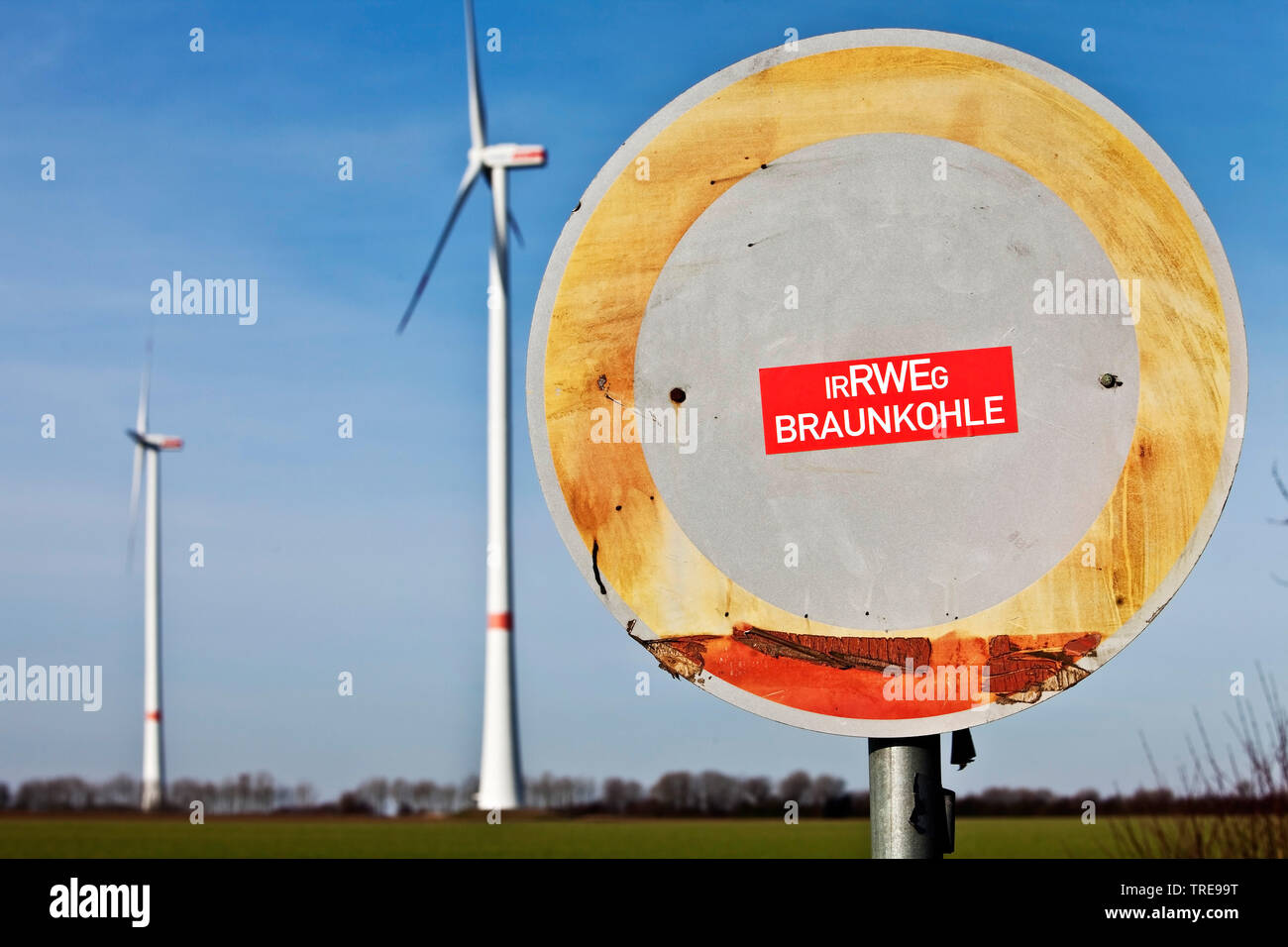 sticker 'IrRWEg Braunkohle' on a traffic sign 'No thoroughfare' and wind plants, Germany, North Rhine-Westphalia, Grevenbroich Stock Photo
