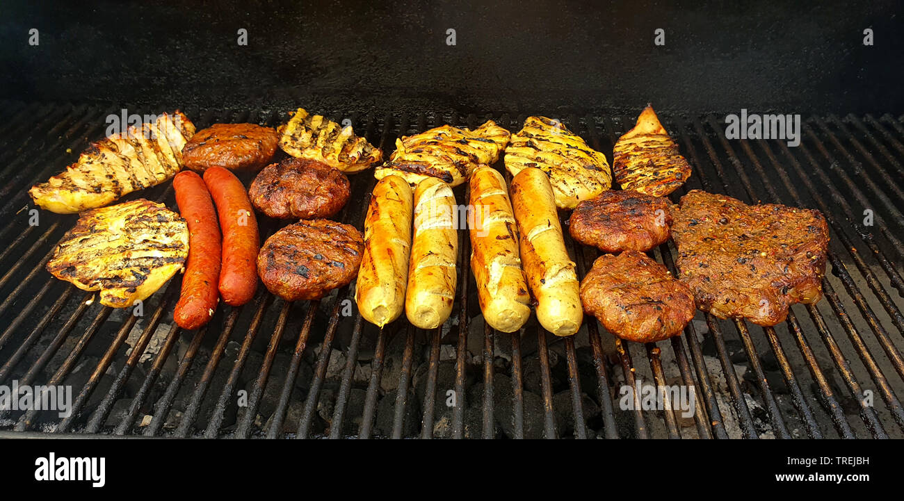 meat and sausages on a grill Stock Photo