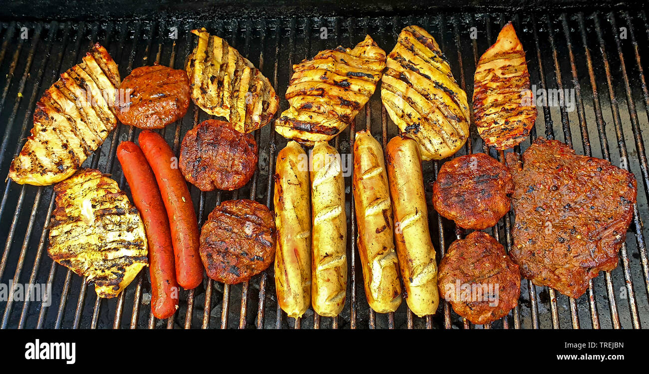 meat and sausages on a grill Stock Photo