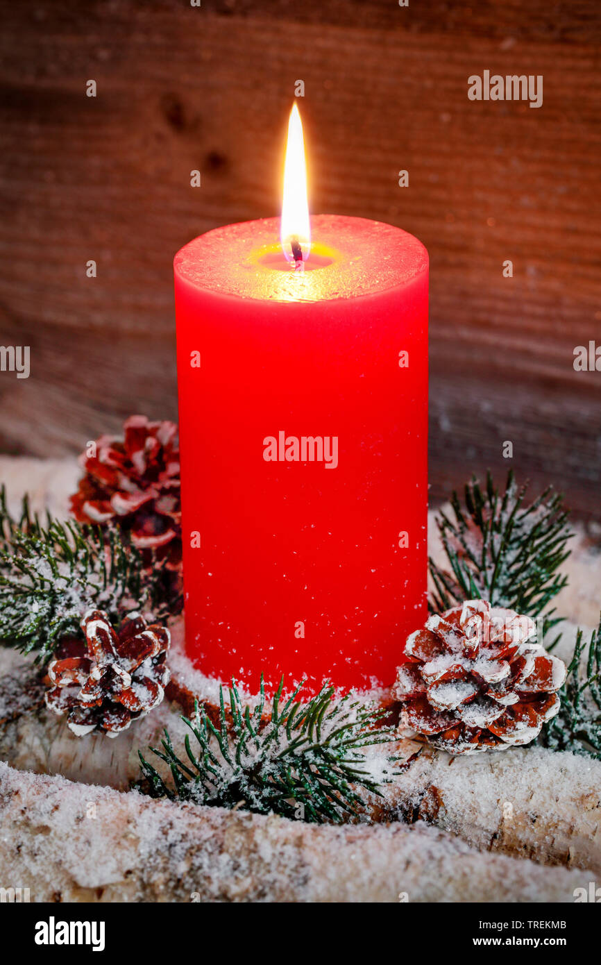 burning red candle with Christmas decoration Stock Photo