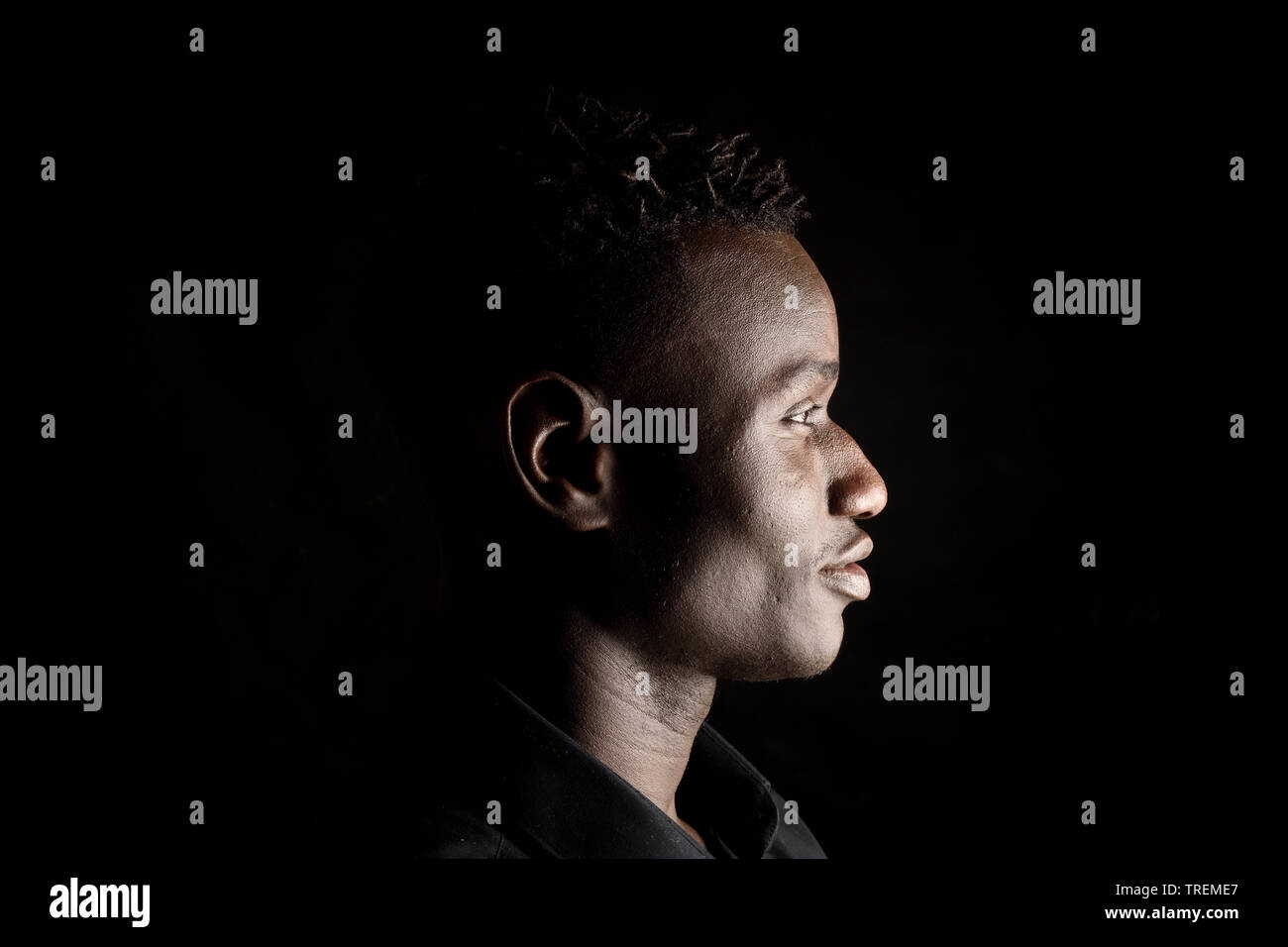 portrait of a african man on black background,profile Stock Photo Alamy